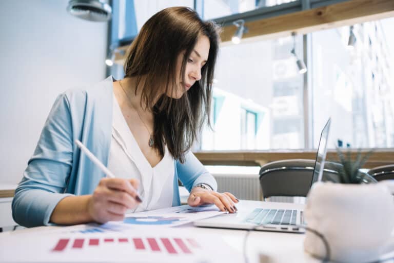 Resolved IT | IT Services for Accounting & Finance firms woman with pen using laptop